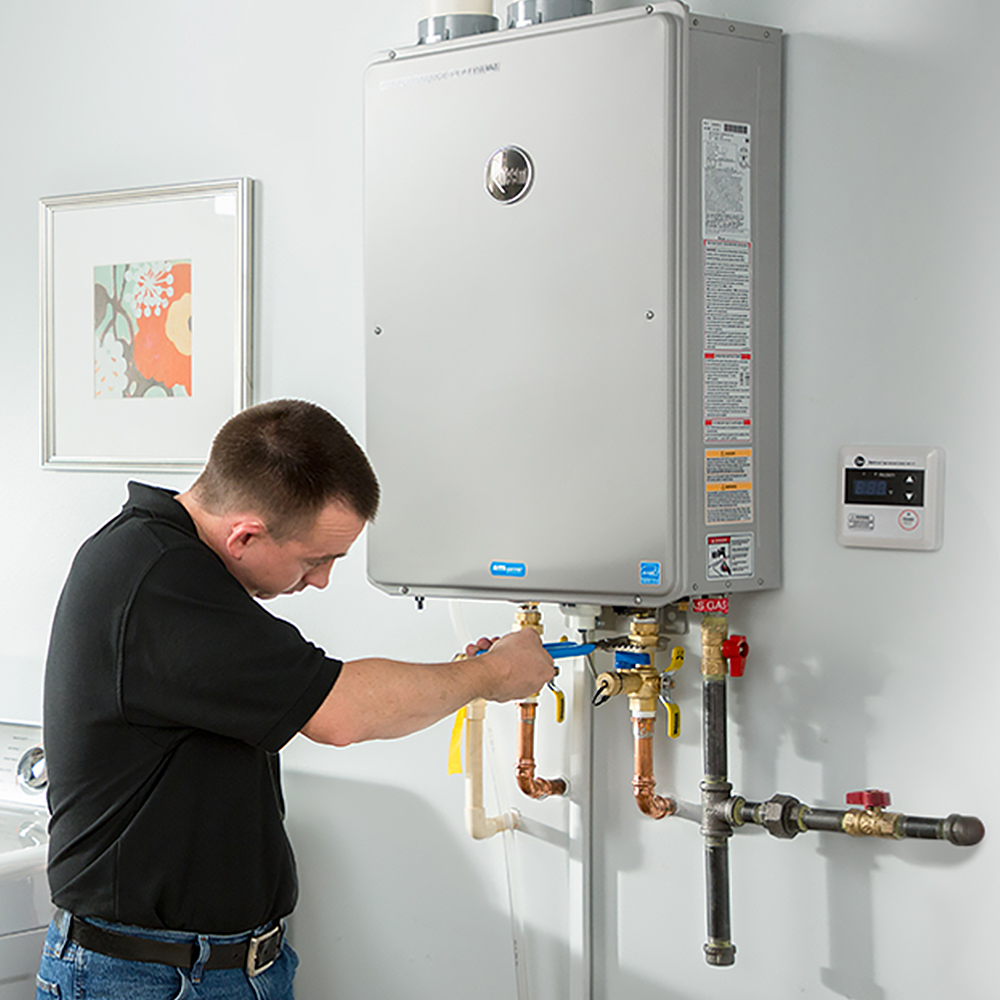 heat pump repair service man working on unit on wall