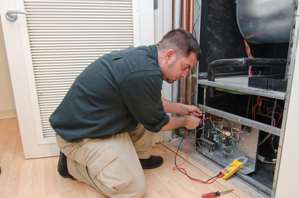 HVAC technician working on a heat pump in Salt Lake City UT